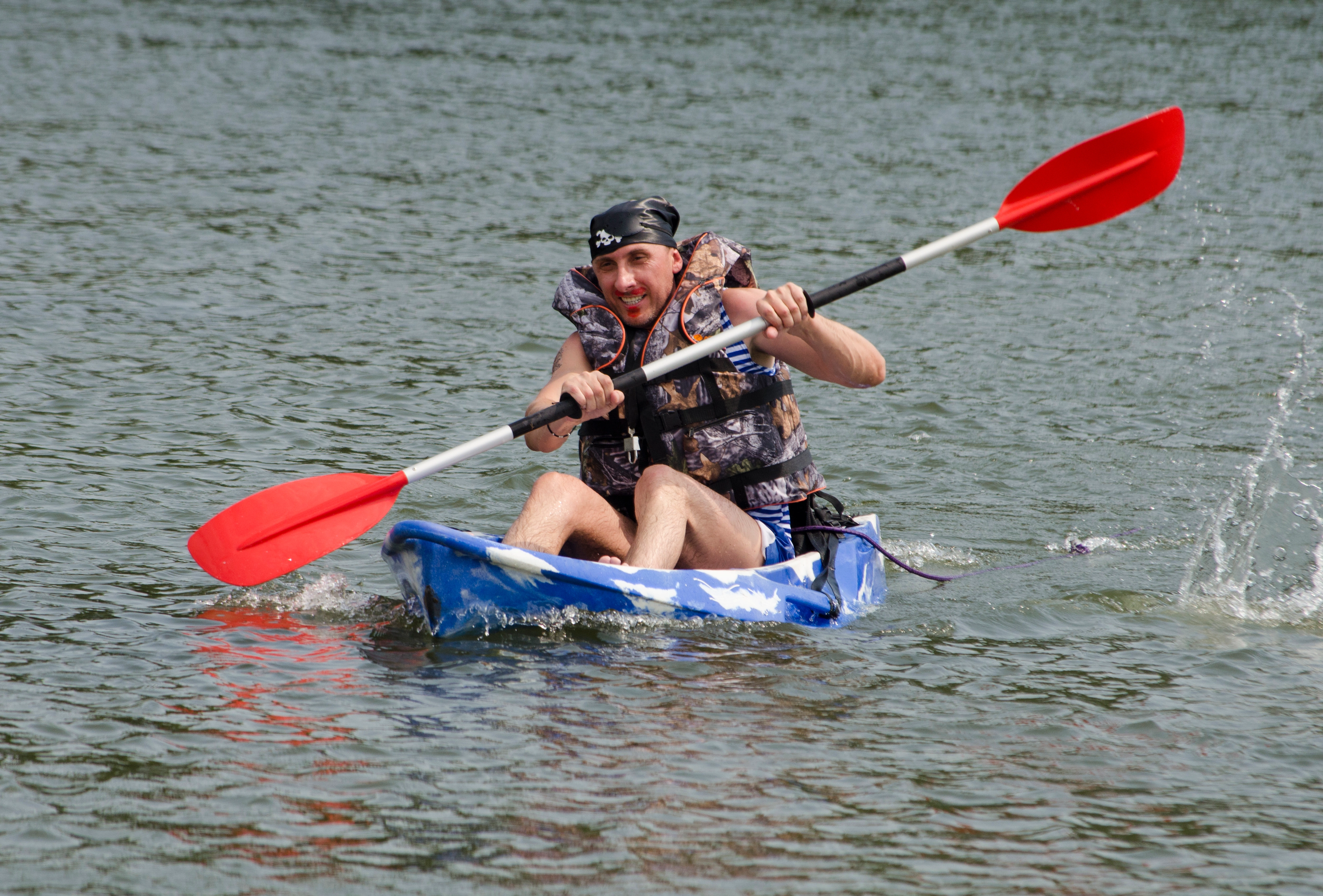 Participanți într-o cursă pe apă cu bărci improvizate, activitate de teambuilding tip Goana Corsarilor, ideală pentru spirit de echipă și distracție